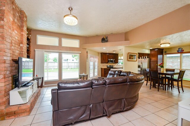 4318 Glen Avon Dr, Pasadena, TX 77505 - living room with a textured ceiling, light tile patterned floors, and plenty of natural light