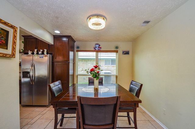4318 Glen Avon Dr, Pasadena, TX 77505 - dining area with light tile patterned flooring and a textured ceiling