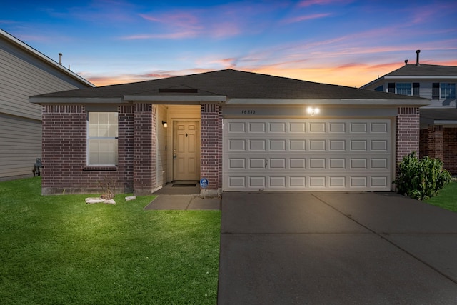 16810 Perryton Ln, Houston, TX 77073 - view of front of house featuring brick siding, concrete driveway, a garage, and a yard