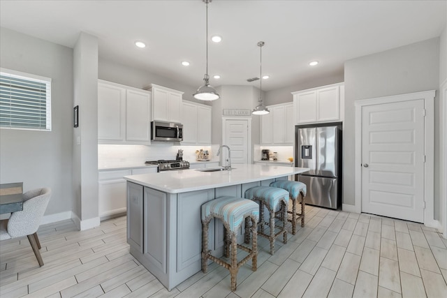 18635 Parkland Square Pl, Cypress, TX 77433 - kitchen featuring appliances with stainless steel finishes, wood tiled floors, tasteful backsplash, light countertops, and white cabinets