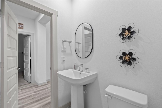 6214 Bois D Arc St, League City, TX 77573 - bathroom with wood finished floors and toilet