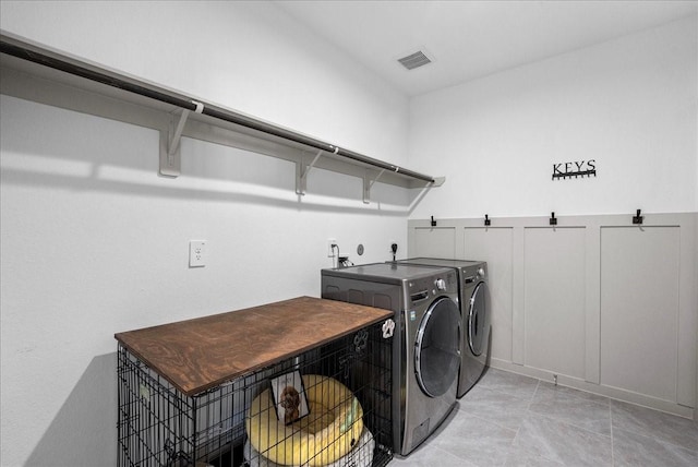 6214 Bois D Arc St, League City, TX 77573 - laundry room featuring washing machine and clothes dryer and light tile patterned floors