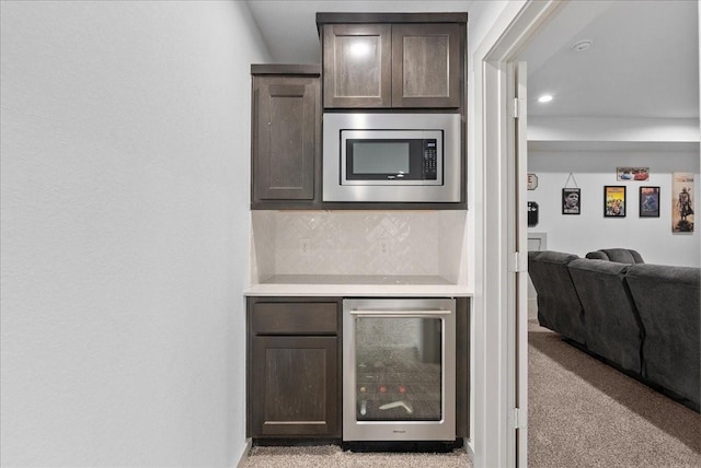 6214 Bois D Arc St, League City, TX 77573 - bar featuring stainless steel microwave, beverage cooler, backsplash, and light colored carpet
