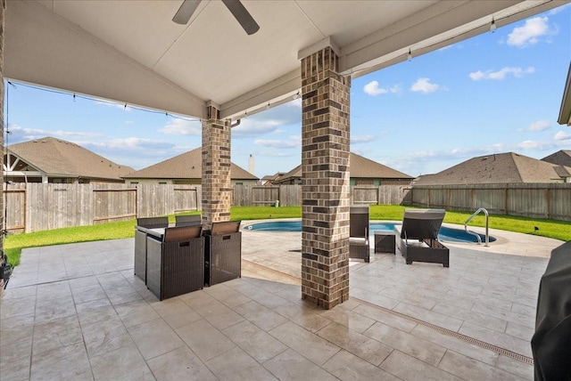 6214 Bois D Arc St, League City, TX 77573 - fenced backyard with ceiling fan, a patio area, and outdoor dining space