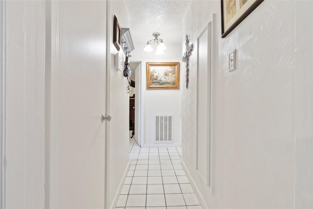826 Ivyhollow Dr, Channelview, TX 77530 - corridor featuring light tile patterned flooring and a textured ceiling