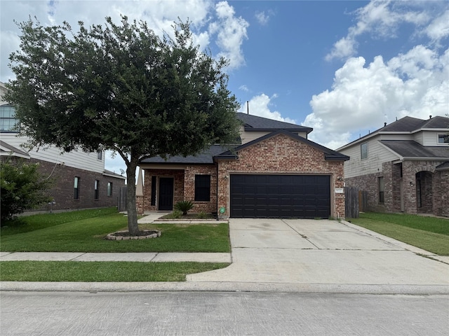 9022 Saint Laurent Ln, Houston, TX 77044 - view of front of house featuring a garage, a front lawn, brick siding, and driveway