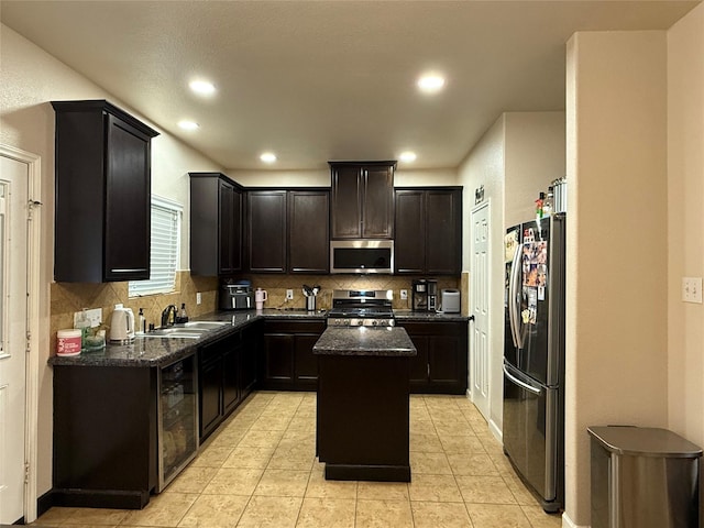 9022 Saint Laurent Ln, Houston, TX 77044 - kitchen with appliances with stainless steel finishes, a kitchen island, tasteful backsplash, dark stone counters, and recessed lighting