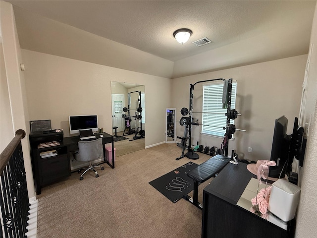 9022 Saint Laurent Ln, Houston, TX 77044 - exercise room with light colored carpet and a textured ceiling