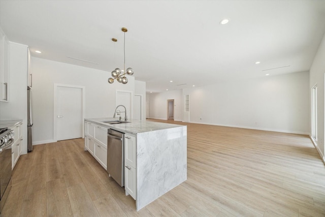 10225 Shadow Oaks Dr, Houston, TX 77043 - kitchen with appliances with stainless steel finishes, light wood-style flooring, white cabinets, a center island with sink, and light stone countertops