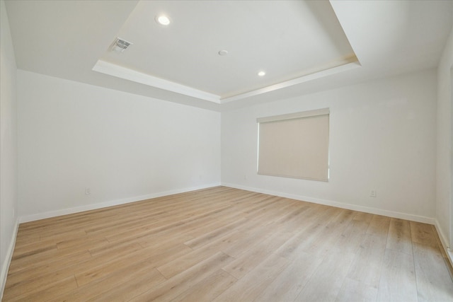 10225 Shadow Oaks Dr, Houston, TX 77043 - spare room with a tray ceiling, recessed lighting, and light wood finished floors