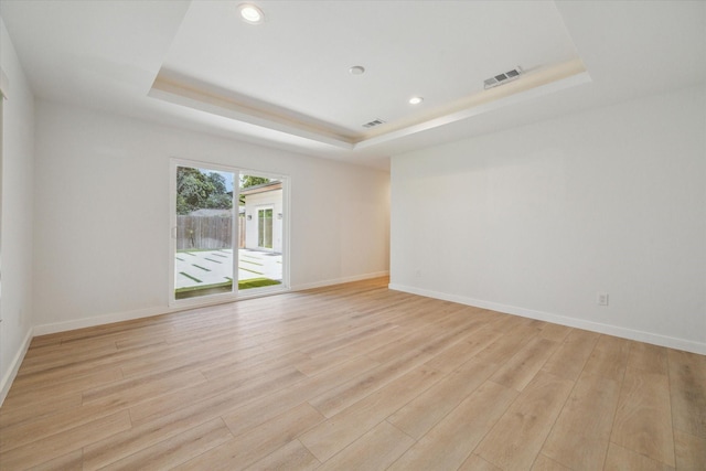 10225 Shadow Oaks Dr, Houston, TX 77043 - spare room featuring a raised ceiling, light wood-style flooring, and recessed lighting