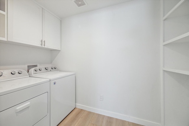 10225 Shadow Oaks Dr, Houston, TX 77043 - laundry area with cabinet space, independent washer and dryer, and light wood-type flooring