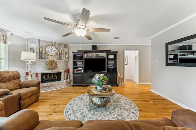 1926 Meadow Creek Dr, Pearland, TX 77581 - living room featuring ceiling fan, light wood-type flooring, crown molding, and a fireplace