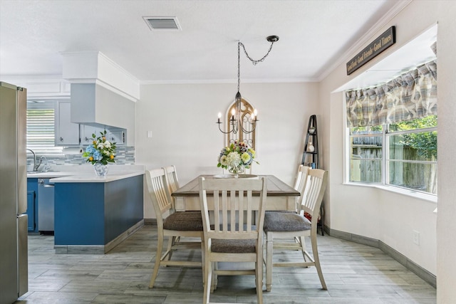 1926 Meadow Creek Dr, Pearland, TX 77581 - dining room with crown molding, light wood finished floors, healthy amount of natural light, and a chandelier