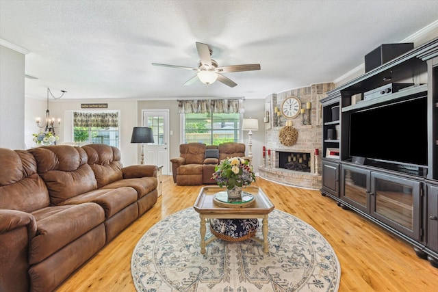 1926 Meadow Creek Dr, Pearland, TX 77581 - living area with a chandelier, a ceiling fan, healthy amount of natural light, light wood finished floors, and ornamental molding