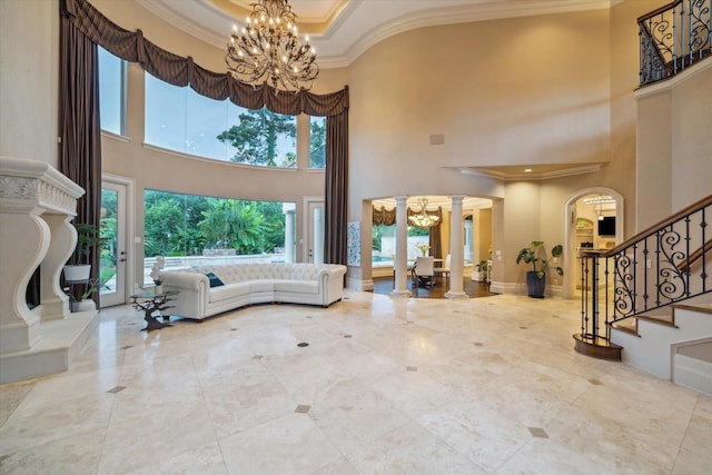 6 Kings Lake Estates Blvd, Kingwood, TX 77346 - entryway with a chandelier, a towering ceiling, crown molding, decorative columns, and stairs