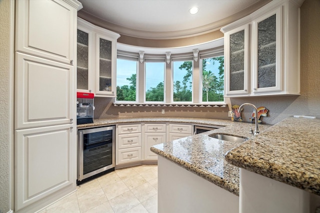 6 Kings Lake Estates Blvd, Kingwood, TX 77346 - kitchen with wine cooler, light stone countertops, glass insert cabinets, light tile patterned floors, and recessed lighting