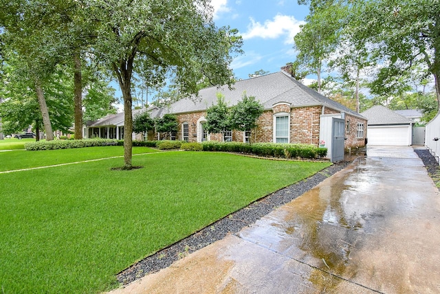 327 Cinnamon Oak Ln, Houston, TX 77079 - view of front of property with a front lawn, brick siding, an outdoor structure, a shingled roof, and a garage