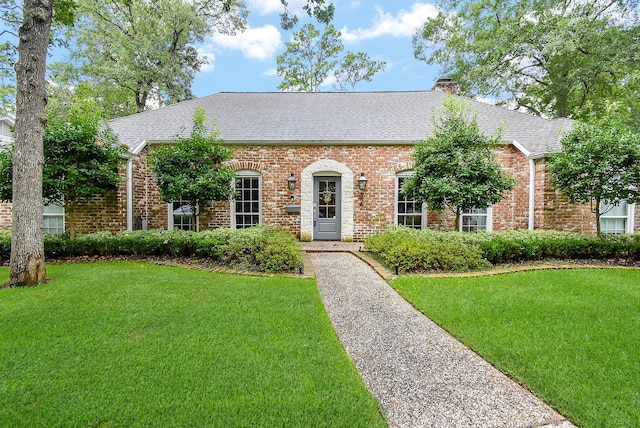 327 Cinnamon Oak Ln, Houston, TX 77079 - view of front facade featuring a front lawn, a shingled roof, and brick siding