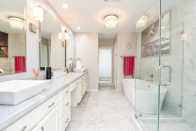 327 Cinnamon Oak Ln, Houston, TX 77079 - bathroom featuring double vanity, a freestanding tub, a chandelier, marble finish flooring, and a stall shower
