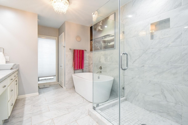 327 Cinnamon Oak Ln, Houston, TX 77079 - full bath with vanity, a freestanding tub, marble look tile flooring, a shower stall, and a chandelier
