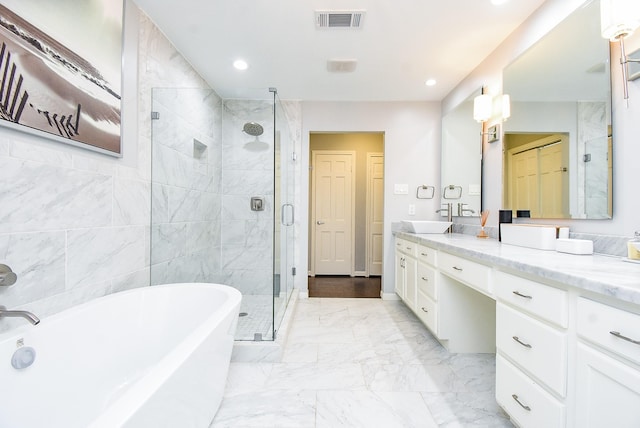 327 Cinnamon Oak Ln, Houston, TX 77079 - bathroom with vanity, a freestanding bath, a stall shower, recessed lighting, and marble finish floors