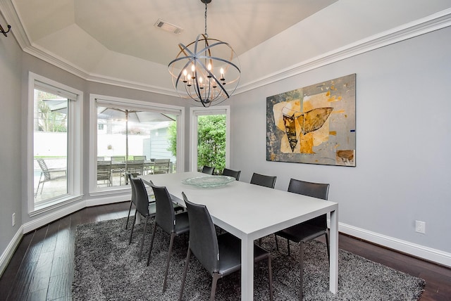 327 Cinnamon Oak Ln, Houston, TX 77079 - dining space with a chandelier, dark wood-style flooring, a tray ceiling, and crown molding
