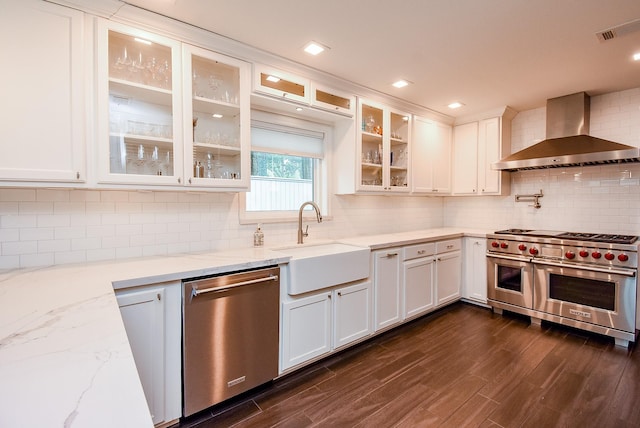 327 Cinnamon Oak Ln, Houston, TX 77079 - kitchen with wall chimney range hood, appliances with stainless steel finishes, and white cabinetry