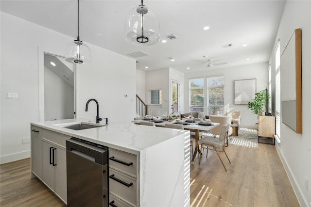 3219 Brewster St, Houston, TX 77026 - kitchen featuring dishwasher, a ceiling fan, light wood finished floors, hanging light fixtures, and recessed lighting