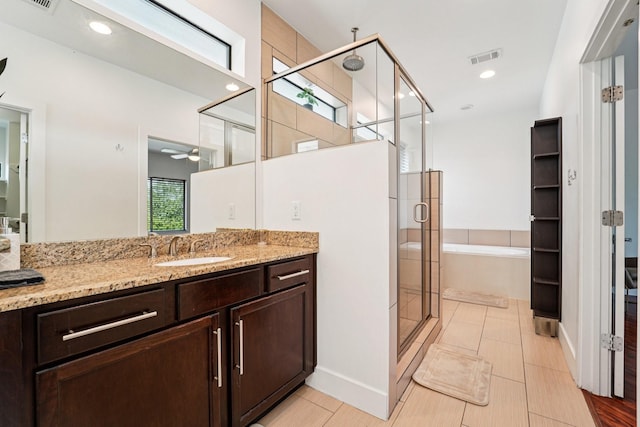 2209 Bastrop St, Houston, TX 77003 - bathroom featuring a stall shower, vanity, a bath, and a ceiling fan