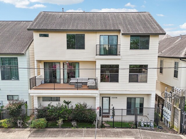 2209 Bastrop St, Houston, TX 77003 - townhome / multi-family property featuring a shingled roof and a fenced front yard