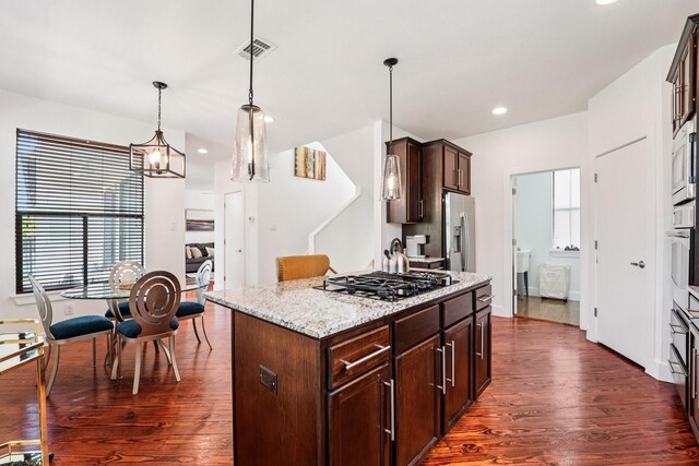 2209 Bastrop St, Houston, TX 77003 - kitchen with stainless steel appliances, dark wood-style flooring, plenty of natural light, dark brown cabinets, and recessed lighting