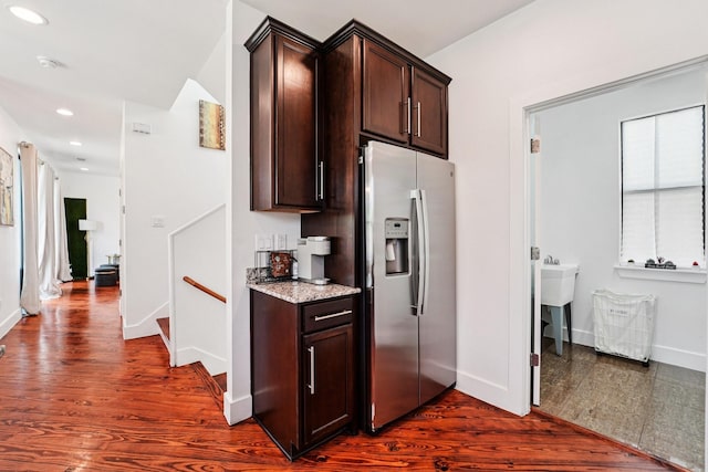 2209 Bastrop St, Houston, TX 77003 - kitchen featuring stainless steel refrigerator with ice dispenser, dark brown cabinets, light stone countertops, dark wood-style floors, and recessed lighting