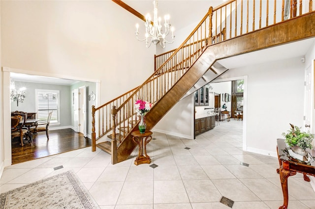 15817 Honolulu St, Jersey Village, TX 77040 - entrance foyer featuring stairway, a towering ceiling, healthy amount of natural light, light tile patterned flooring, and a chandelier