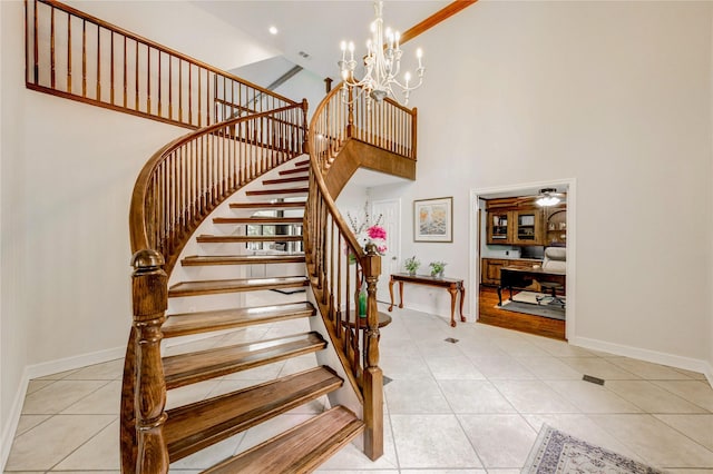 15817 Honolulu St, Jersey Village, TX 77040 - stairway featuring a towering ceiling, tile patterned flooring, a chandelier, and a ceiling fan