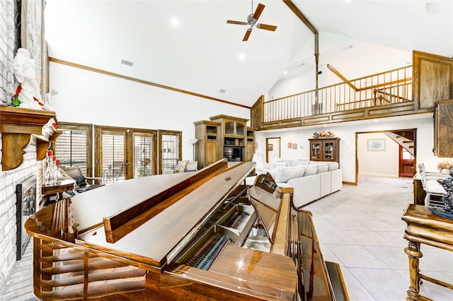 15817 Honolulu St, Jersey Village, TX 77040 - living room with high vaulted ceiling, ceiling fan, a fireplace, stairs, and light tile patterned flooring