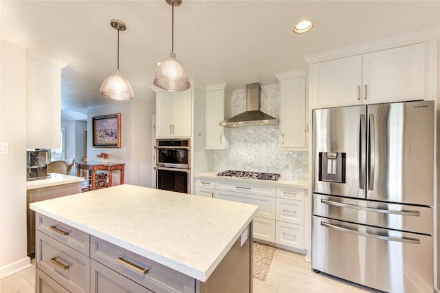 15817 Honolulu St, Jersey Village, TX 77040 - kitchen with appliances with stainless steel finishes, wall chimney exhaust hood, light countertops, recessed lighting, and white cabinetry