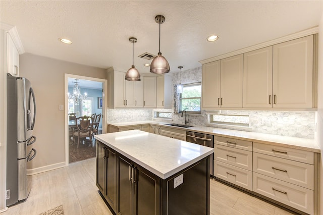 15817 Honolulu St, Jersey Village, TX 77040 - kitchen with appliances with stainless steel finishes, light countertops, recessed lighting, backsplash, and a chandelier