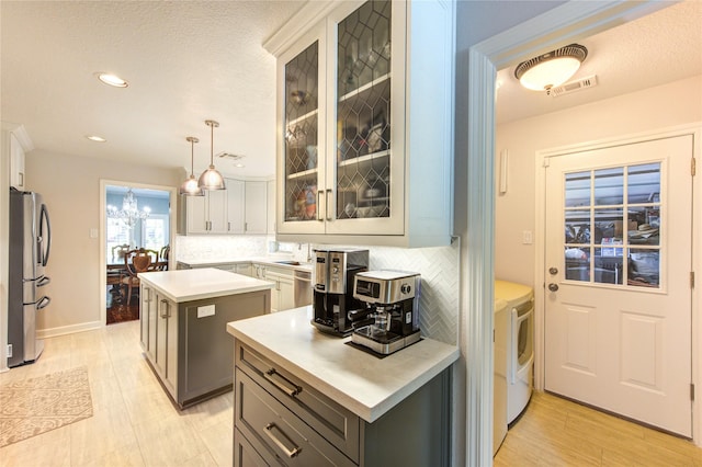 15817 Honolulu St, Jersey Village, TX 77040 - kitchen with stainless steel fridge with ice dispenser, light countertops, a kitchen island, tasteful backsplash, and recessed lighting