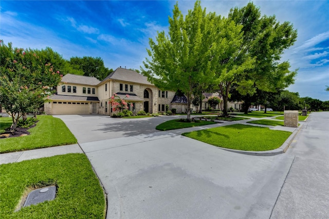 15817 Honolulu St, Jersey Village, TX 77040 - view of front of home featuring stone siding, driveway, a garage, and a front yard