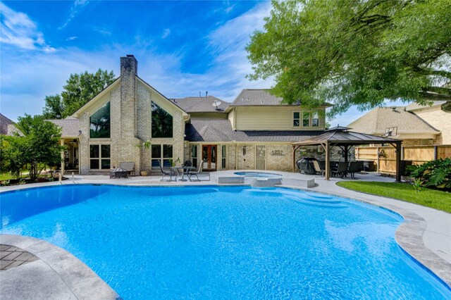 15817 Honolulu St, Jersey Village, TX 77040 - view of swimming pool featuring a gazebo, a patio, and a pool with connected hot tub