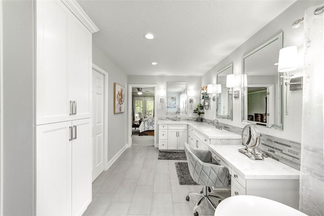 15817 Honolulu St, Jersey Village, TX 77040 - ensuite bathroom featuring recessed lighting, vanity, a textured ceiling, ceiling fan, and tile patterned flooring