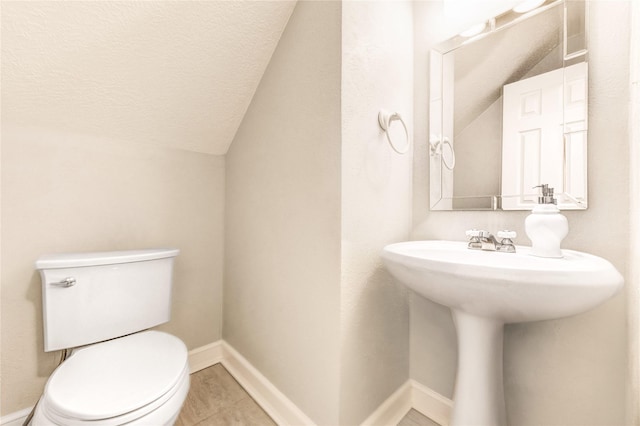 15817 Honolulu St, Jersey Village, TX 77040 - half bathroom featuring vaulted ceiling, tile patterned flooring, and a textured ceiling