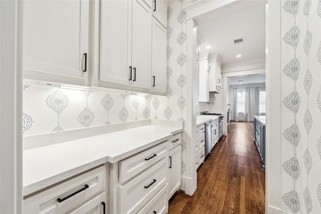 727 Tulane St, Houston, TX 77007 - kitchen with white cabinets, light countertops, dark wood-style flooring, tasteful backsplash, and appliances with stainless steel finishes