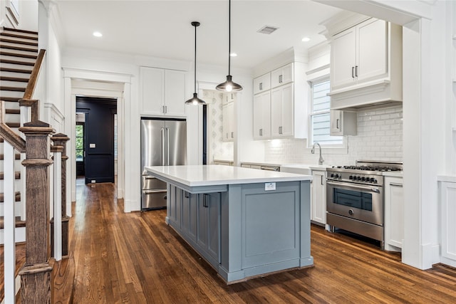 727 Tulane St, Houston, TX 77007 - kitchen with stainless steel appliances, light countertops, white cabinetry, ornamental molding, and recessed lighting