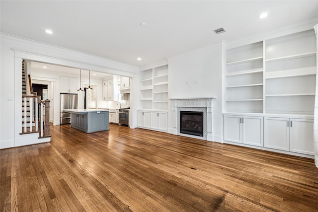 727 Tulane St, Houston, TX 77007 - unfurnished living room with dark wood-type flooring, ornamental molding, stairway, a high end fireplace, and recessed lighting