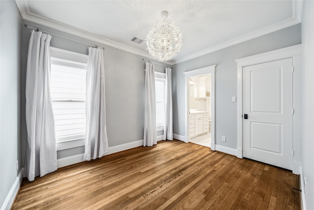 727 Tulane St, Houston, TX 77007 - unfurnished bedroom with a chandelier, wood finished floors, ornamental molding, and ensuite bathroom