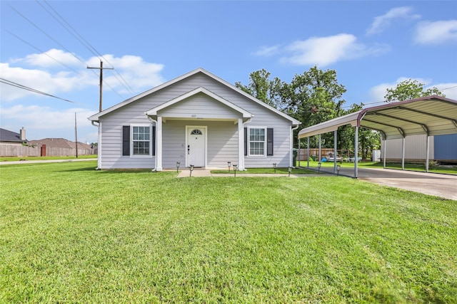 605 Waco St, Dayton, TX 77535 - view of front of property featuring a front lawn, a carport, and driveway
