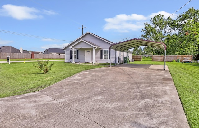 605 Waco St, Dayton, TX 77535 - view of front facade with driveway and a carport