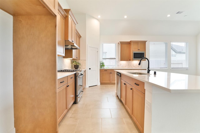 24526 Bluestar Blossom Trl, Katy, TX 77493 - kitchen with appliances with stainless steel finishes, decorative backsplash, under cabinet range hood, light countertops, and recessed lighting